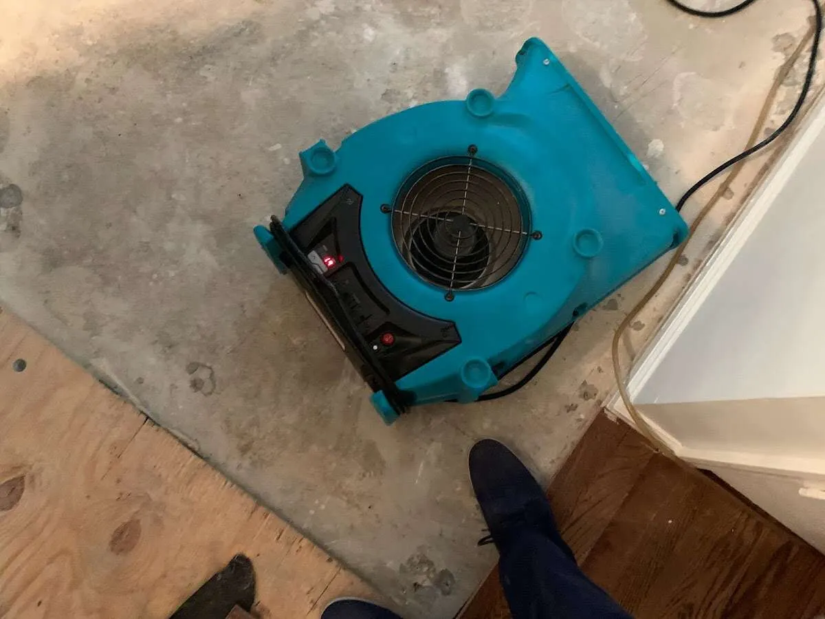 Air mover drying subfloor during Commercial Water Damage Restoration in Amory